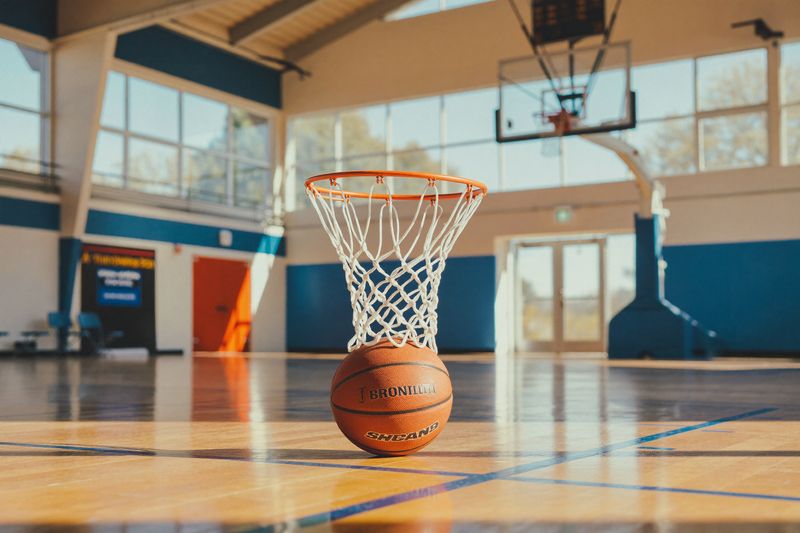 A basketball on the floor of a sunlit gym — the Rising Stars intro league.