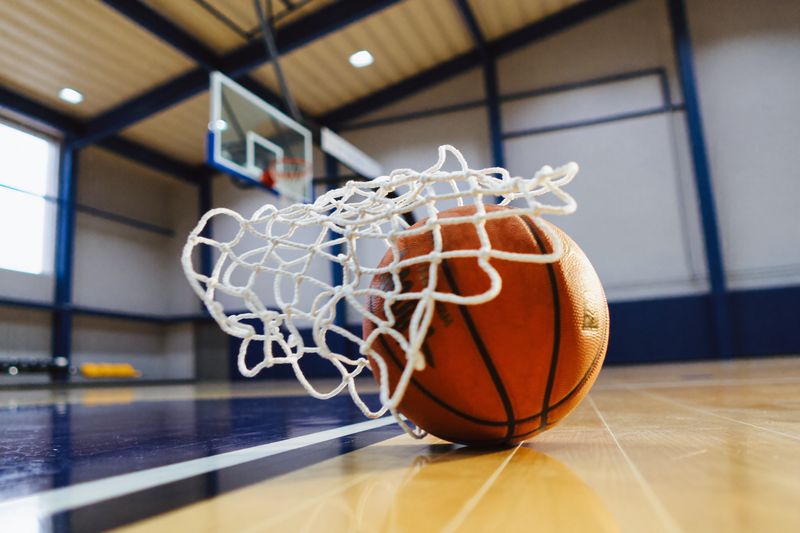 A basketball dropping through the net in the IMPACT Sports gym.